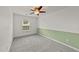 Cozy bedroom with neutral carpeting, ceiling fan, and ample natural light at 1120 Renewal Pl # 111, Raleigh, NC 27603