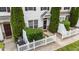 Up close front exterior of townhouse featuring a white picket fence and small front yard at 1120 Renewal Pl # 111, Raleigh, NC 27603