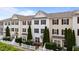 Townhouse exteriors showcasing varied siding colors, black shutters and tidy landscaping at 1120 Renewal Pl # 111, Raleigh, NC 27603