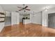 Open-concept living room with hardwood floors, a staircase, and seamless flow into the kitchen area at 1120 Renewal Pl # 111, Raleigh, NC 27603