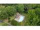 Aerial view of a community pool surrounded by lounge chairs and tables with mature trees at 1134 Deerfoot Trail Trl, Sanford, NC 27332