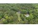 Expansive property with a long driveway leading to a house and community pool surrounded by lush trees at 1134 Deerfoot Trail Trl, Sanford, NC 27332
