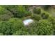 Aerial view of a fenced community swimming pool with lounge chairs surrounded by mature trees at 1134 Deerfoot Trail Trl, Sanford, NC 27332