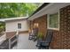 Back deck with rocking chairs and lovely views of the wooded lot at 1134 Deerfoot Trail Trl, Sanford, NC 27332
