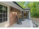 A cozy back deck includes 2 rocking chairs and sliding glass doors at 1134 Deerfoot Trail Trl, Sanford, NC 27332
