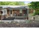 Backyard with deck, landscaping, and brick and siding home at 1134 Deerfoot Trail Trl, Sanford, NC 27332