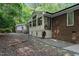 Spacious backyard features a deck, patio, a lush wooded backdrop at 1134 Deerfoot Trail Trl, Sanford, NC 27332