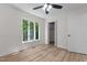 Bedroom featuring large windows providing natural light, ceiling fan, and closet at 1134 Deerfoot Trail Trl, Sanford, NC 27332