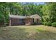 Brick home featuring well-maintained lawn and mature trees at 1134 Deerfoot Trail Trl, Sanford, NC 27332