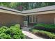 Inviting front entrance with well-maintained landscaping and a glimpse of the cozy interior at 1134 Deerfoot Trail Trl, Sanford, NC 27332