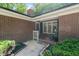 Brick front porch with rocking chair and landscaped garden at 1134 Deerfoot Trail Trl, Sanford, NC 27332