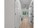 Bright hallway leads to the bedroom with ceiling fan and features doors to other rooms at 1134 Deerfoot Trail Trl, Sanford, NC 27332