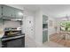 Open kitchen with shaker style cabinetry, stainless steel appliances, and access to the dining room at 1134 Deerfoot Trail Trl, Sanford, NC 27332