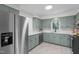 Traditional kitchen features shaker style cabinetry, stainless steel appliances, and tile flooring at 1134 Deerfoot Trail Trl, Sanford, NC 27332