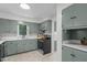 Well-lit kitchen boasts shaker style cabinetry, stainless appliances, and tile flooring at 1134 Deerfoot Trail Trl, Sanford, NC 27332