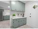 Bright kitchen with shaker style cabinetry, white countertop and access to the backdoor at 1134 Deerfoot Trail Trl, Sanford, NC 27332
