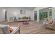 Open living space showcasing seamless transition into bright, sun-filled room, and modern bar seating at 1134 Deerfoot Trail Trl, Sanford, NC 27332