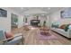 Cozy living room featuring a brick fireplace, wood floors and lots of natural light at 1134 Deerfoot Trail Trl, Sanford, NC 27332