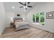 Bright main bedroom boasts a vaulted ceiling, large windows and wood grain floors at 1134 Deerfoot Trail Trl, Sanford, NC 27332