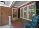 Charming brick porch with decorative door and ample windows offering a view to the house's interior at 1134 Deerfoot Trail Trl, Sanford, NC 27332