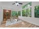 Bright sun room featuring a brick accent wall, wood floors, large windows and backyard views at 1134 Deerfoot Trail Trl, Sanford, NC 27332
