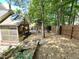 Spacious backyard with wood fence, screened in porch and mature trees at 121 Chimney Rise Dr, Cary, NC 27511