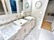 Bathroom with marble counters, double sinks, and large mirror above vanity at 121 Chimney Rise Dr, Cary, NC 27511