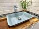 Close up of a lovely light blue vessel sink with chrome faucet and wood countertop at 121 Chimney Rise Dr, Cary, NC 27511