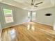Primary bedroom featuring hardwood floors, ceiling fan, tray ceiling, and lots of natural light at 121 Chimney Rise Dr, Cary, NC 27511