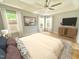 Staged bedroom with neutral tones, hardwood floors, ceiling fan, and natural light at 121 Chimney Rise Dr, Cary, NC 27511
