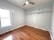 Empty bedroom featuring hardwood floors, shelving, and a ceiling fan at 121 Chimney Rise Dr, Cary, NC 27511