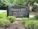 Beautiful neighborhood signage with gold lettering and attractive landscaping at Chimney Rise Lakeside at 121 Chimney Rise Dr, Cary, NC 27511