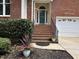 Brick home with an arched doorway, well-maintained landscaping, and a two-car garage at 121 Chimney Rise Dr, Cary, NC 27511