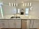 Modern kitchen with gray cabinets, stainless steel appliances, granite countertops, and stylish lighting at 121 Chimney Rise Dr, Cary, NC 27511