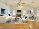 Bright, open living room with fireplace, large ceiling fan, and view to the adjacent eat-in kitchen at 121 Chimney Rise Dr, Cary, NC 27511