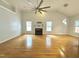 Spacious living room with hardwood floors, a fireplace, and large windows, offering a bright atmosphere at 121 Chimney Rise Dr, Cary, NC 27511