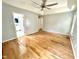 Spacious main bedroom featuring hardwood floors, ceiling fan, and ensuite bathroom at 121 Chimney Rise Dr, Cary, NC 27511