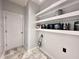 Large room with white door, white shelves, and tile floor at 121 Chimney Rise Dr, Cary, NC 27511