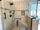 Modern shower with glass enclosure, built-in seat, and tiled surround at 121 Chimney Rise Dr, Cary, NC 27511