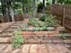Backyard garden featuring tiered planter boxes, stone steps and mature landscaping at 121 Chimney Rise Dr, Cary, NC 27511