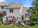 Exterior view of home's backyard with patio, landscaping and outdoor seating areas at 12221 Orchardgrass Ln, Raleigh, NC 27614