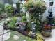 Beautifully landscaped backyard garden with stone statues, potted plants, and a variety of flowers at 12221 Orchardgrass Ln, Raleigh, NC 27614