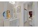 Bright bathroom with white cabinets, silver hardware, and a view to the bathtub at 12221 Orchardgrass Ln, Raleigh, NC 27614