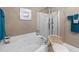 A pristine bathroom featuring a soaking tub, glass shower, and tile flooring at 12221 Orchardgrass Ln, Raleigh, NC 27614