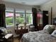 Comfortable bedroom with large windows, wood floors and a decorative armoire at 12221 Orchardgrass Ln, Raleigh, NC 27614