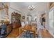 Elegant dining room with hardwood floors, chandelier, and decorative china cabinet at 12221 Orchardgrass Ln, Raleigh, NC 27614