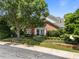 Charming brick home featuring mature landscaping, a well-manicured lawn, and a welcoming front porch at 12221 Orchardgrass Ln, Raleigh, NC 27614