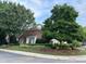 Charming brick home featuring meticulously manicured front yard and mature trees at 12221 Orchardgrass Ln, Raleigh, NC 27614
