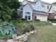 Beautiful two-story home with brick and siding exterior complemented by lush landscaping at 12221 Orchardgrass Ln, Raleigh, NC 27614