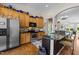 The kitchen features stainless steel appliances, natural wood cabinets, and granite counters at 12221 Orchardgrass Ln, Raleigh, NC 27614